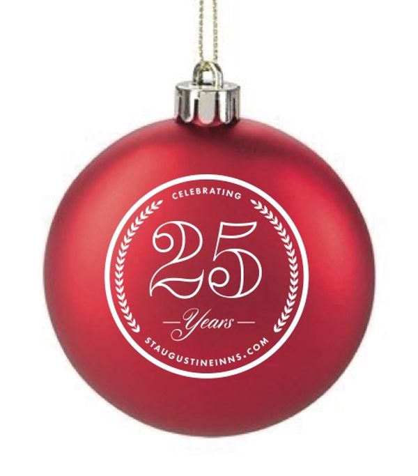 red Christmas ball with white lettering in circle: Celebrating 25 Years