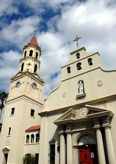 The exterior of the Cathedral Bascilica of St. Augustine. A spire rises on the left and a bell tower rises on the right.