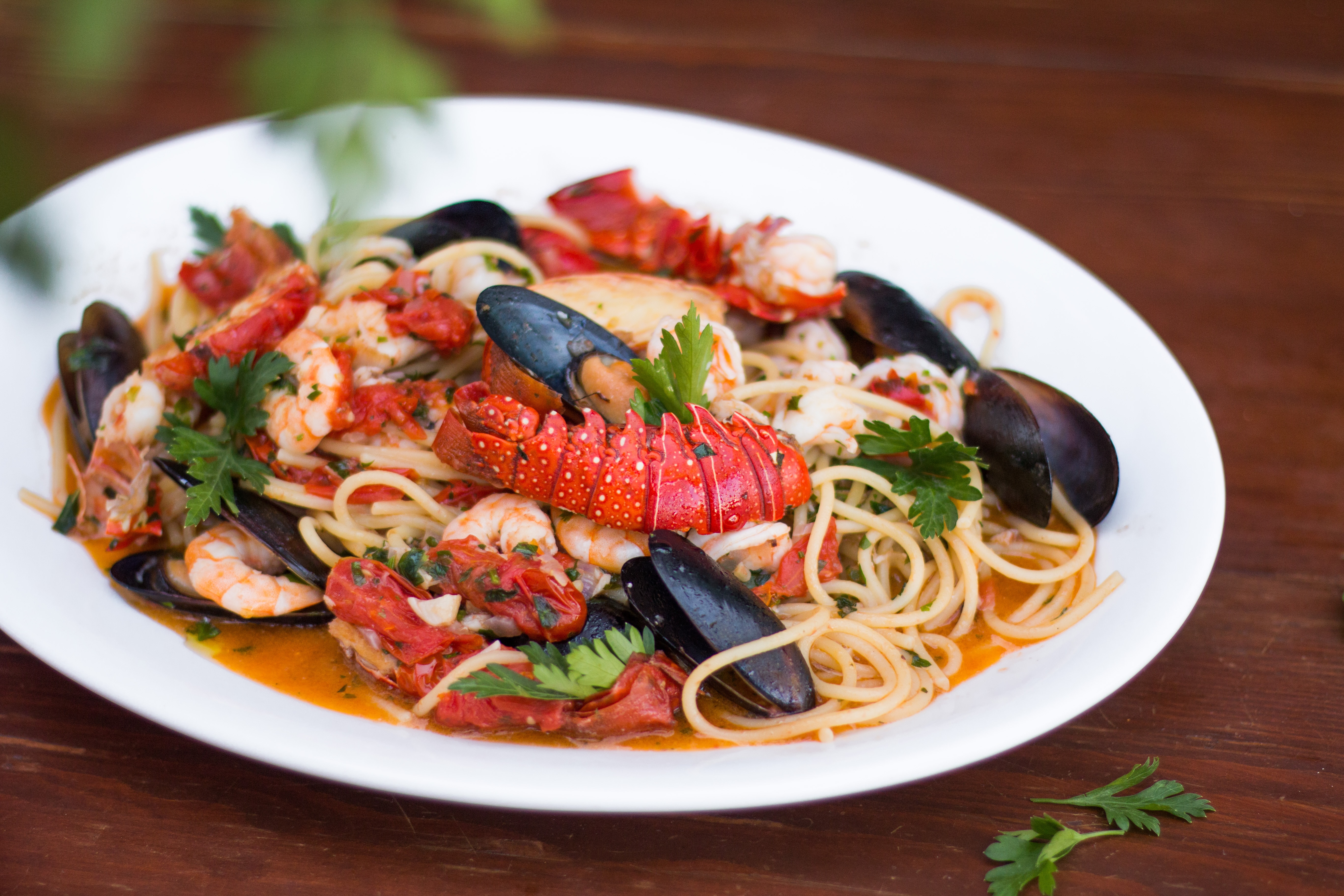A dish of seafood pasta served on a white plate.